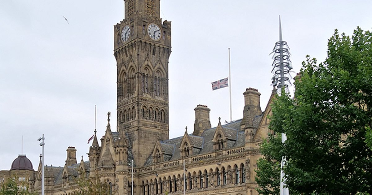 Bradford city centre showing the City Park mirror pool and historic Wool Exchange building