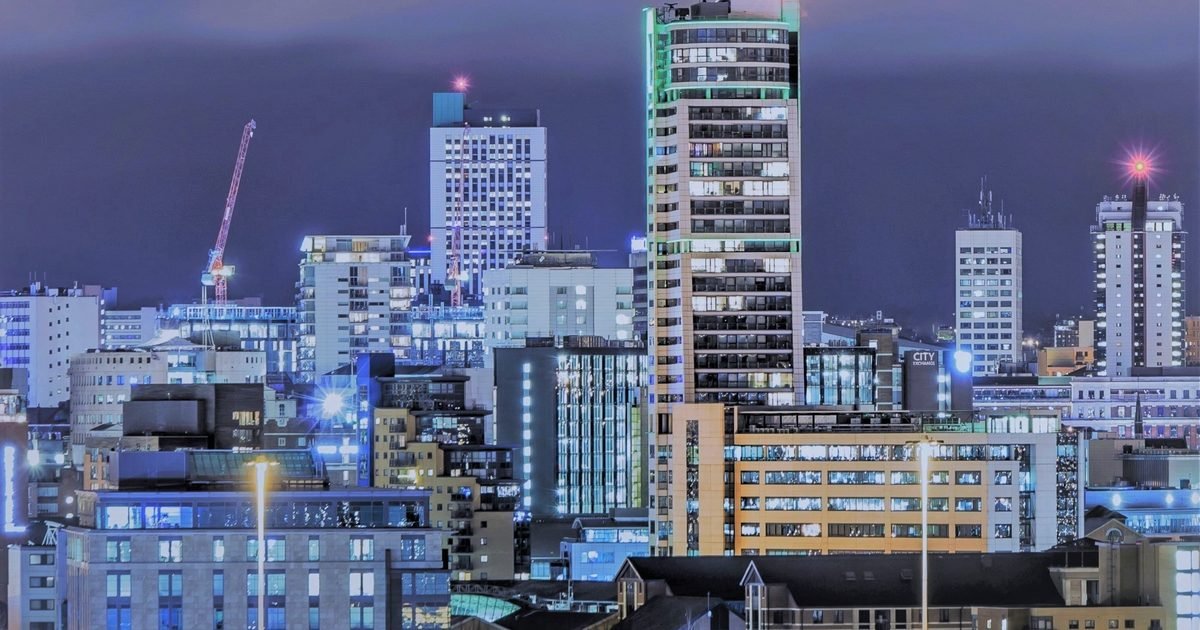 Leeds city centre at dusk showing Bridgewater Place and the Leeds canal basin with modern apartments