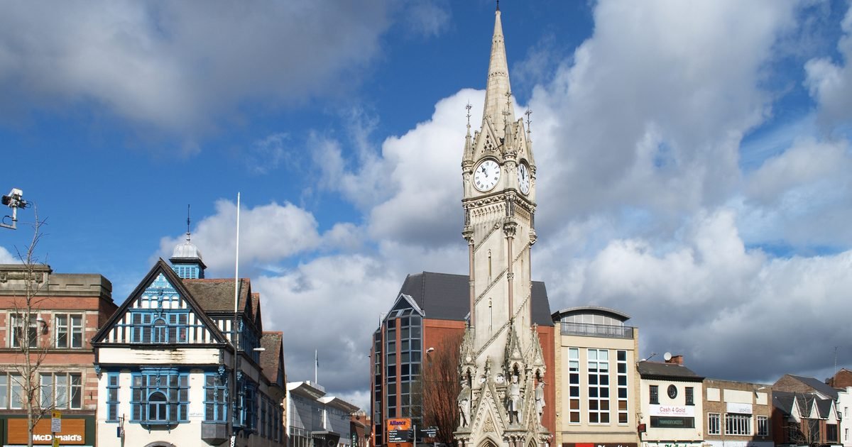 Leicester Clock Tower at dusk with people walking through the city centre pedestrian zone